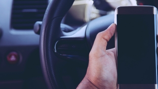 Holding a mobile phone in a car