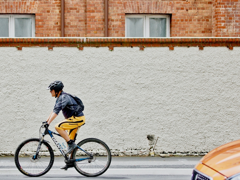 Man riding bike on street